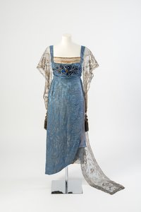 Blue Figured Silk Evening Dress with Gold Net Sleeves and Train Embroidered in Gold Metal Strip and Decorated with Blue Gems and Tassels, 1911